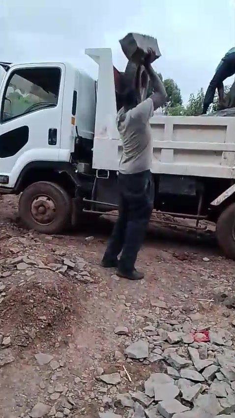 Workers loading stones onto the lorry at the quarry