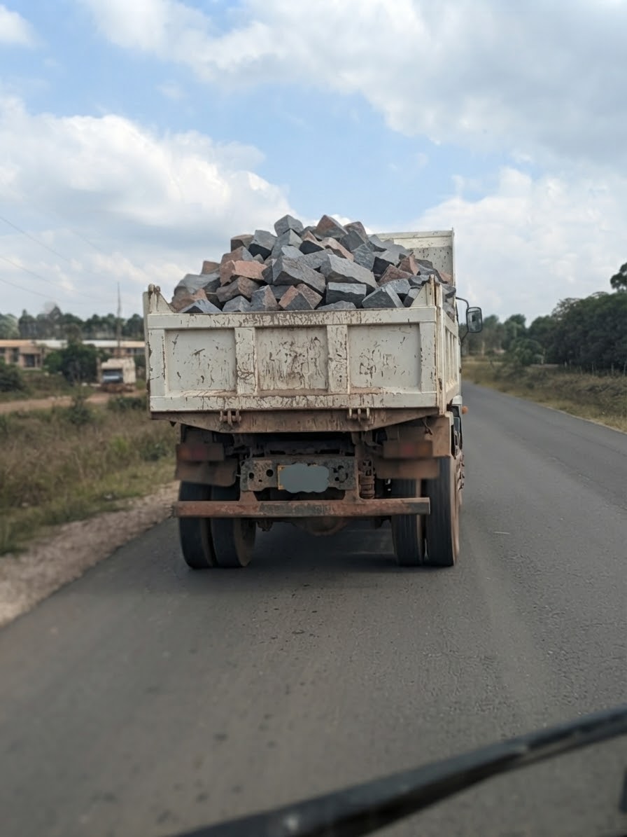 Loaded lorry transporting stones on the road